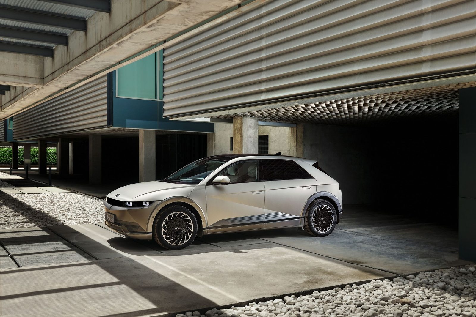 Hyundai IONIQ 5 gris clair stationné sous un bâtiment en béton