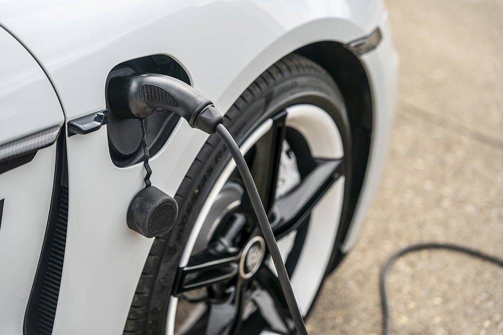 Câble de recharge branché sur la trappe avant d'une voiture électrique blanche lors d'une journée d'essais SMMT au Royaume-Uni